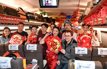 Bullet train staff perform to extend Spring Festival greetings to passengers